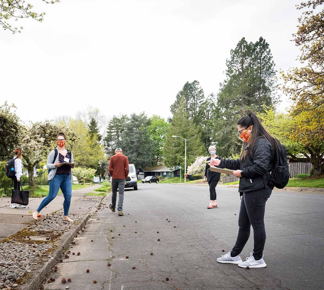 TRACE field staff walking along neighborhood street.